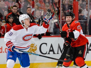 Nathan Beaulieu #28 of the Montreal Canadiens and Zack Smith #15 of the Ottawa Senators try to knock down a puck in mid air during the NHL game at Canadian Tire Centre on October 11, 2015 in Ottawa.