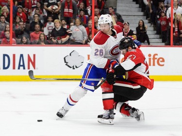 Jeff Petry #26 of the Montreal Canadiens takes down Curtis Lazar #27 of the Ottawa Senators during the NHL game at Canadian Tire Centre on October 11, 2015 in Ottawa.