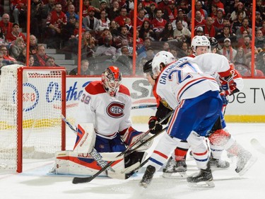 Goaltender Mike Condon #39 of the Montreal Canadiens tries to protect his net during the NHL game against the Ottawa Senators at Canadian Tire Centre on October 11, 2015 in Ottawa.