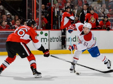 David Desharnais #51 of the Montreal Canadiens takes a shot in front of Patrick Wiercioch #46 of the Ottawa Senators during the NHL game at Canadian Tire Centre on October 11, 2015 in Ottawa.