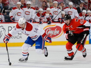 Tomas Plekanec #14 of the Montreal Canadiens breaks away from Erik Karlsson #65 of the Ottawa Senators and scores during the NHL game at Canadian Tire Centre on October 11, 2015 in Ottawa.