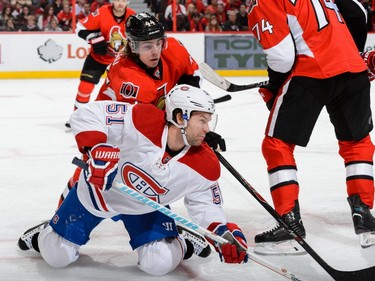 Jean-Gabriel Pageau #44 of the Ottawa Senators takes down David Desharnais #51 of the Montreal Canadiens during the NHL game at Canadian Tire Centre on October 11, 2015 in Ottawa.