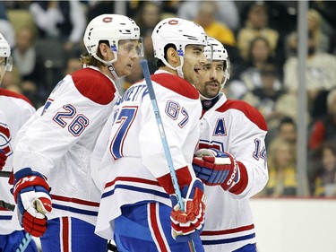 Max Pacioretty (#67) of the Montreal Canadiens celebrates his second-period goal with teammates Jeff Petry (#26) and Tomas Plekanec (#14) during the game against the Pittsburgh Penguins at Consol Energy Center on October 13, 2015 in Pittsburgh, Pennsylvania.