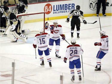 Tomas Fleischmann (#15) of the Montreal Canadiens celebrates with teammates after scoring on Marc-André Fleury (#29) of the Pittsburgh Penguins in the third period during the game at Consol Energy Center on October 13, 2015 in Pittsburgh, Pennsylvania.
