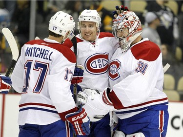 Canadiens goalie Carey Price celebrates with Tomas Fleischmann and Torrey Mitchell after defeating the Penguins 3-2 at Consol Energy Center in Pittsburgh on Oct. 13, 2015.