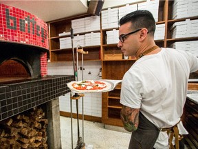 Fabrizio Covone prepares the pizza  margherita at Bottega Pizzeria. The wood-burning oven was imported from Italy, brick by brick.