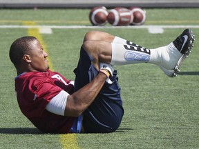 "When I got benched ... (I thought) look, I've come from nothing, I've had to eat from shelters. I've done everything and I'm still playing football. I'm still getting opportunities. I'm still getting paid." says Alouettes rush-end John Bowman, stretching during practice in August.