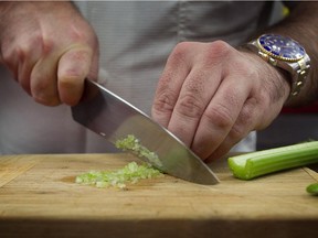 Chef Jerome Ferrer chops celery at Europea in Montreal in 2012.