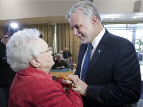 Quebec Liberal leader Philippe Couillard, right, meets seniors at  Residence Angelica in Montreal North, Monday, March 17, 2014.
