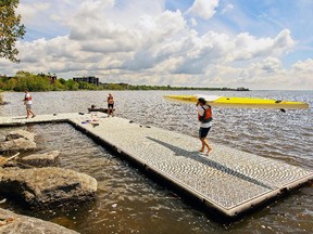 John Cornellier carries his kayak on a temporary dock at Pointe Claire Canoe Club in May 2014.  How can the nightmare scenario of a raw-sewage dump be unfolding in the waters around Montreal?