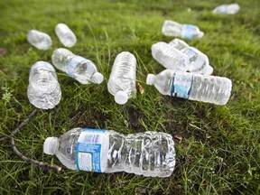 Empty bottles left as garbage on the grass outside an office building in Lachine in Montreal.