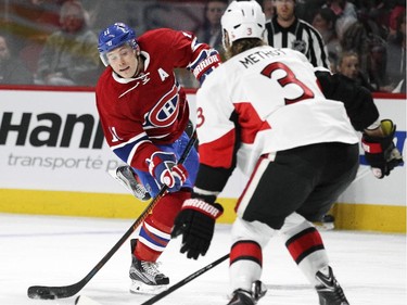 Montreal Canadiens Brendan Gallagher tries to shoot the puck past Ottawa Senators Marc Methot during a National Hockey League pre-season game in Montreal Thursday October 1, 2015.