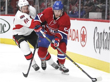 Montreal Canadiens Charles Hudon is checked by Ottawa Senators Mark Stone during a National Hockey League pre-season game in Montreal Thursday October 1, 2015.