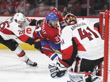 Montreal Canadiens Devonte Smith-Pelley, (#21), cuts to the net past Ottawa Senators Matt Ruempel as goalie Craig Anderson cuts off the short side during a National Hockey League pre-season game in Montreal Thursday October 1, 2015.