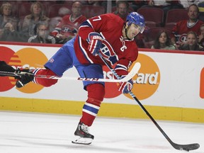 Canadiens' Max Pacioretty shoots the puck while being checked by Senators' Mike Hoffman during a National Hockey League pre-season game at the Bell Centre on Thursday, Oct. 1, 2015.