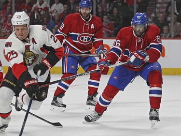 Montreal Canadiens P.K. Subban, right, knocks the puck off the stick of Ottawa Senators Chris Neal while Habs Andrei Markov watches, rear, during a National Hockey League pre-season game in Montreal Thursday October 1, 2015.