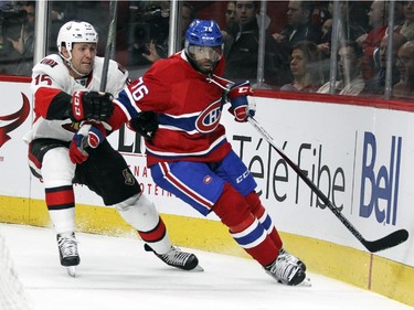 Montreal Canadiens P.K. Subban, right, is checked by Ottawa Senators Zack Smith during a National Hockey League pre-season game in Montreal Thursday October 1, 2015.