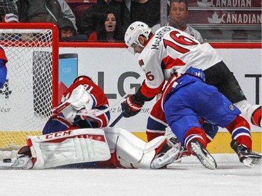 Ottawa Senators Clarke Macarthur scores on Montreal Canadiens defencemen Tom Gilbert, left, and Alexei Emelin and goalie Carey Price during a National Hockey League pre-season game in Montreal Thursday October 1, 2015.