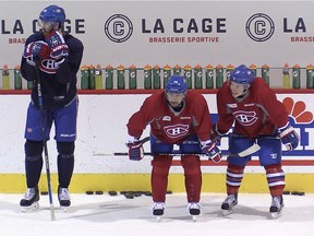 Canadiens defenceman Jarred Tinordi (far left) looks away from teammates Tomas Plekanec (centre) and Brendan Gallagher during practice at the Bell Sports Complex in Brossard on Oct. 2, 2015.