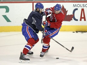 Canadiens defenceman Jared Tinordi, left, stops Tomas Fleischmann during practice at the team's training facility in Brossard, outside Montreal Monday October 5, 2015. (John Mahoney / MONTREAL GAZETTE)