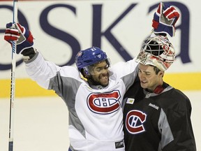 Canadiens' Devante Smith-Pelley celebrates with goalie Carey Price during practice at the team's training facility in Brossard, outside Montreal on Tuesday October 6, 2015. (John Mahoney / MONTREAL GAZETTE)