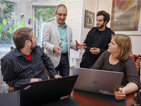 Hacking Health Montreal co-founder Luc Sirois speaks with group members Sylvain Ethier, left, Jacob Lavigne and Stephanie Pataracchia in Maison Jeanne Sauvé in Montreal on Wednesday October 07, 2015. Hacking Health began as a way to connect Montreal's hospitals to entrepreneurs to help stir innovation in medicine and healthcare.
