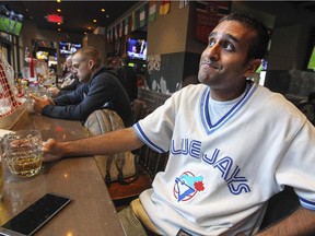 Toronto Blue Jays fan and Toronto native Sam Bhachech watches the Jays American League playoff game on the one television out of six near the bar at Sports Station bar in Montreal Thursday October 08, 2015.
