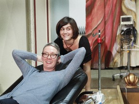 The nurse's lounge at the Royal Victoria Hospital site acts as the theatre for Alyson Grant’s latest play, Progress! She's seen here, on a hospital bed, with stage designer Cassandre Chatonnier.