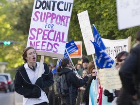 William Strachan, 16, student at Westmount High School, runs during a protest by students, parents, teachers and supporters at the school in Westmount on Thursday Oct. 1, 2015.