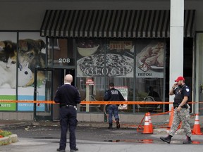 MONTREAL, QUE.: October 13, 2015 -- Police at Pizza Dorval Express in Dorval, west of Montreal Tuesday October 13, 2015.  The pizzeria was hit with a molotov cocktail earlier in the morning. (John Mahoney / MONTREAL GAZETTE)