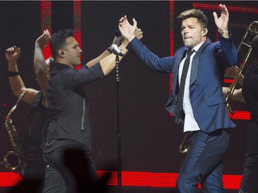 Latin pop singer Ricky Martin (right) urges the audience to clap in time during his performance at the Bell Centre Wednesday, October 14, 2015 in Montreal. The 43-year old is a native of Puerto Rico.