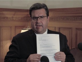 Montreal mayor Denis Coderre holds up an email from Environment Canada at a press conference in Montreal Wednesday, Oct. 14, 2015 after Environment Canada gave their ruling on the city of Montreal's plan to dump  sewage into the St. Lawrence river.