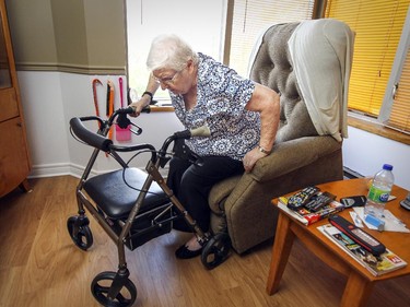 MONTREAL, QUE.: October 15, 2015 -- Agathe Moses, 79, stuggles to get up from her chair in her Cote St-Paul home in a subsidized seniors apartment building in Montreal Thursday October 15, 2015. (John Mahoney / MONTREAL GAZETTE)