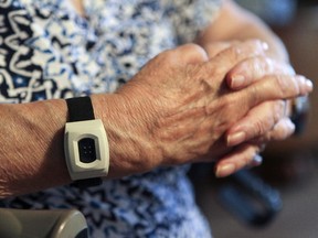 Agathe Moses wears a bracelet from an emergency alert company in her Cote St-Paul home in a subsidized seniors apartment building in Montreal Thursday October 15, 2015.