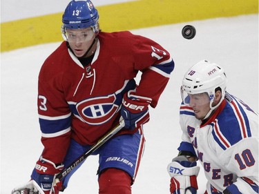 Alexander Semin  of the Montreal Canadiens keeps his eye on a flying puck beside J.T. Miller of the New York Rangers in the first period in NHL action at the Canadiens' home opener at the Bell Centre Thursday, October 15, 2015 in Montreal.