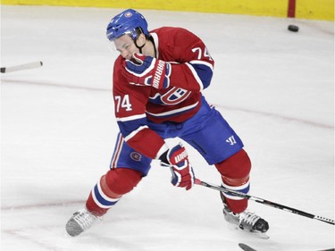 Alexei Emelin of the Montreal Canadiens grabs his face after a hit by Rick Nash of the New York Rangers in the first period in NHL action at the Canadiens' home opener at the Bell Centre Thursday, October 15, 2015 in Montreal. Emelin received an embellishment penalty on the play and Nash was also penalized.