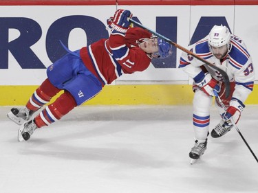 Brendan Gallagher of the Montreal Canadiens is hit by Keith Yandle of the New York Rangers in the third period of NHL action at the Canadiens' home opener at the Bell Centre Thursday, October 15, 2015 in Montreal.
