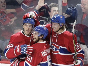 Dale Weise, David Desharnais and Jeff Petry (from the left)  of the Montreal Canadiens celebrate a third-period goal by Weise against the New York Rangers in NHL action at the Canadiens' home opener at the Bell Centre Thursday, October 15, 2015 in Montreal.