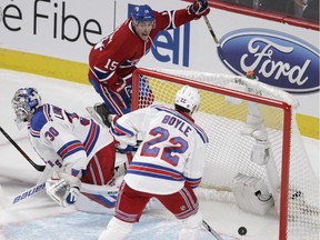 Canadiens' Tomas Fleischmann of the celebrates his second-period goal against Rangers' Henrik Lundqvist, while defenceman Dan Boyle looks on Thursday night at the Bell Centre.