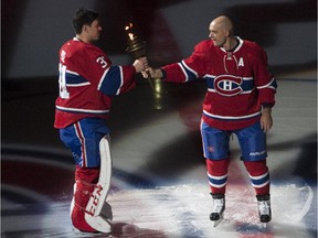Canadiens alternate captain Andrei Markov offers torch to Carey Price during opening ceremonies prior to NHL action at the Canadiens' home opener at the Bell Centre on Thursday, October 15, 2015.
