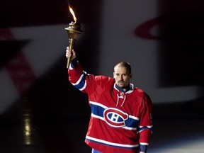 Canadiens alternate captain Tomas Plekanec holds a torch at the opening ceremonies prior to  the Canadiens' home opener at the Bell Centre Thursday, October 15, 2015 in Montreal. (John Kenney / MONTREAL GAZETTE)