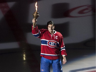 Montreal Canadiens captain Max Pacioretty holds a flame at the opening ceremonies prior to NHL action at the Canadiens' home opener at the Bell Centre Thursday, October 15, 2015 in Montreal.
