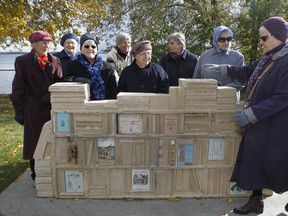 Soeur Louisette Paradis, far right, walks by Shelley Miller's sculpture to join the other sisters from la Congregation of Notre-Dame for a picture on Sunday in Pointe-Claire. This work of public art commemorates the presence of the Sisters of the Congregation of Notre-Dame in Pointe-Claire for over 230 years. (Marie-France Coallier / MONTREAL GAZETTE)