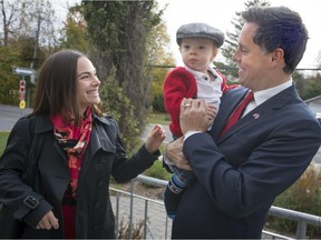 Liberal candidate Peter Schiefke holds his son Anderson as he waits with his wife Paula  Ruttel to vote in his riding of Vaudreuil-Soulanges, in Vaudreuil-sur-le-lac on Monday, October 19, 2015. (Peter McCabe / MONTREAL GAZETTE)