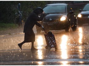 A woman crosses a Montreal street during a rainy October day in 2011.