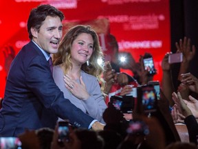 Prime minister-elect Justin Trudeau and wife Sophie Grégoire-Trudeau greet supporters at the Liberal Party's election night headquarters in Montreal early on Tuesday, Oct. 20, 2015.