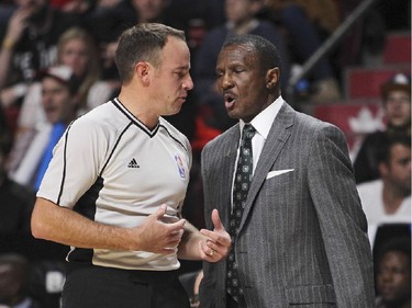 Toronto Raptors coach Dwayne Casey has words with referee Josh Tiven during National Basketball League pre-season game against the Washington Wizards in Montreal Friday October 23, 2015.