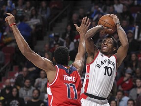 Toronto Raptors DeMar DeRozan shoots a jump shot over Garrett Temple of the Washington Wizards during National Basketball League pre-season game in Montreal Friday October 23, 2015.