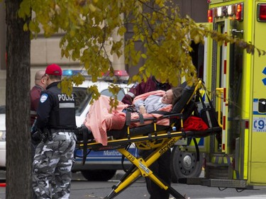 A simulation participant playing the role of a victim is loaded in to an ambulance during a terror attack simulation in Montreal on Saturday, Oct. 24, 2015.