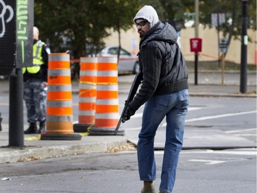 An participant works his way down the street after shooting two soldiers during a terror attack simulation in Montreal on Saturday, Oct. 24, 2015. The shooters began their attack at the Black Watch regiment and moved to police headquarters during the simulation.